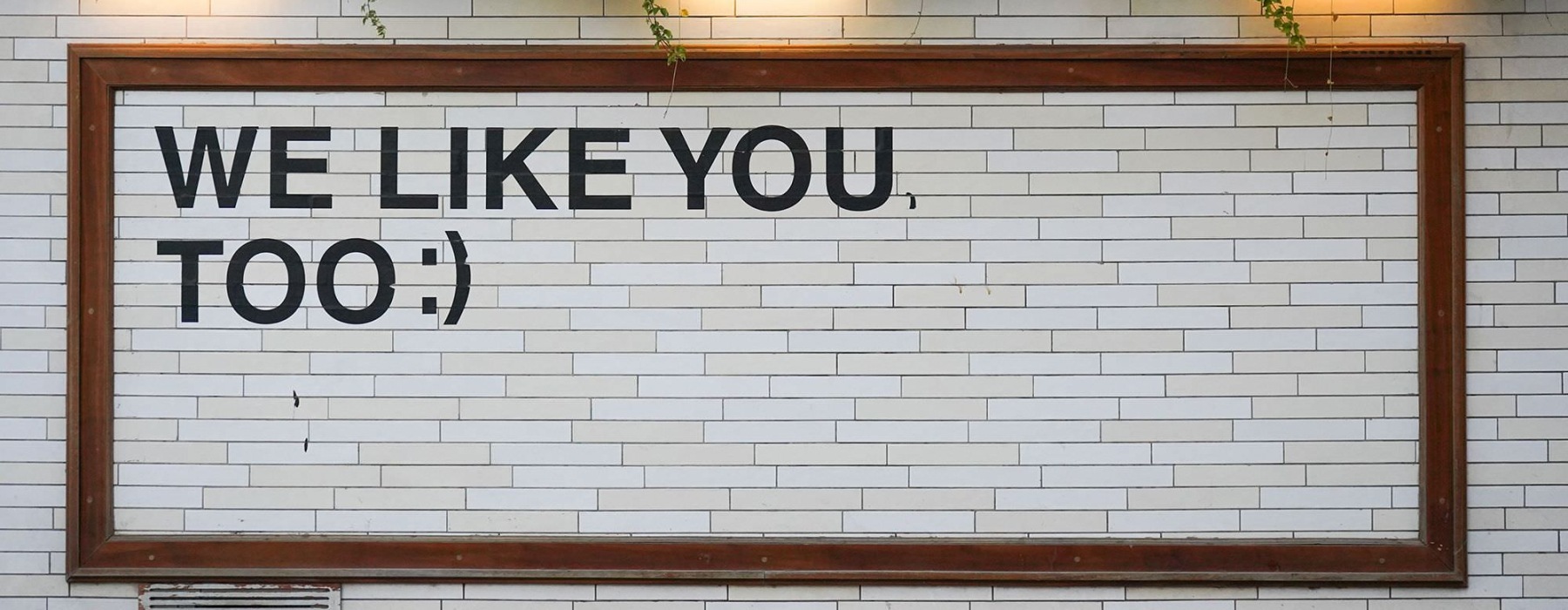 a sign on a tile wall that says 