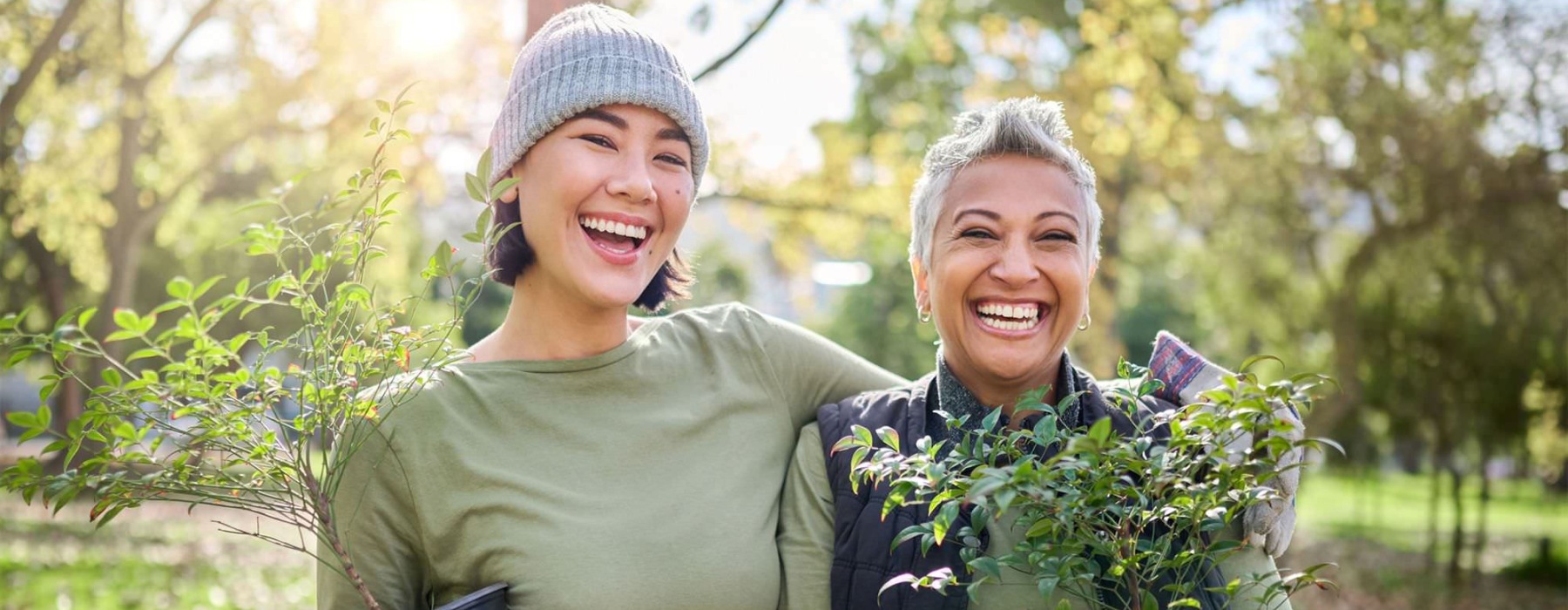a couple of women holding plants